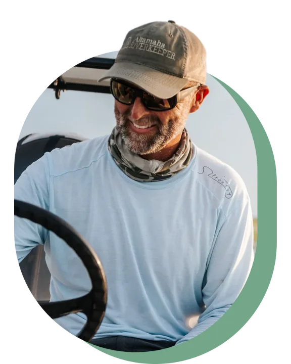 Captain Scott Dykes at the helm of his skiff