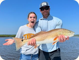 Couple holding a redfish