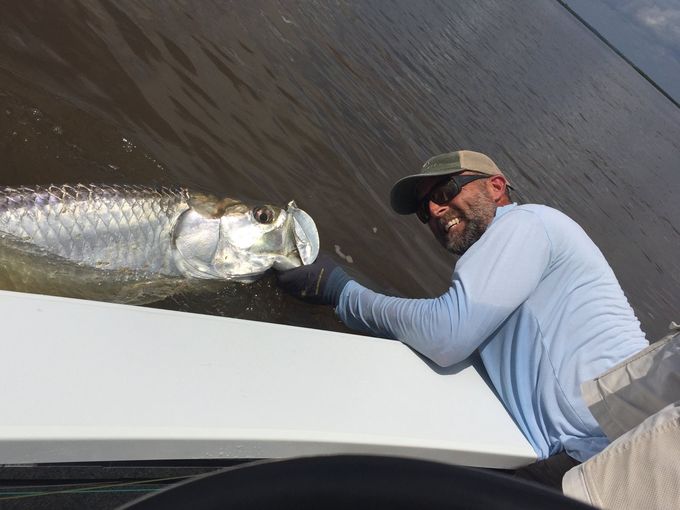 Captain Scott Dykes releasing a tarpon
